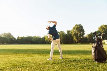 Young,Male,Golfer,Stretching,Muscles,Before,Starting,The,Game,At